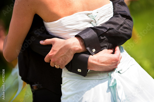 Photo: Newlyweds tenderly embracing. Newlyweds tenderly embracing.