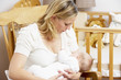 Mother Breastfeeding Baby In Nursery