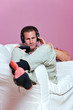 Man sat in an armchair listening to music