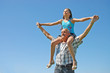 grandfather with the grand daughter against the dark blue sky