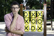 Boy playing tic tac toe