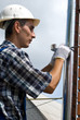 Man installing  rain gutter system