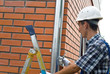 Man installing  rain gutter system