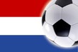 Soccer ball in front of Netherlands flag, close-up