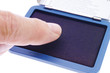 Finger on ink pad, close-up