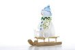 Toy snowman on sledge, close-up