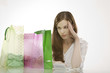 Young womanwith shopping bags, thinking, portrait