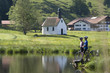 Germany, Bavaria, Allgaeu, Couple with mountain bikes standing on lakeshore