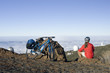 Spain, The Canary Islands, La Palma, Woman with mountain bike taking a break, looking over clouds