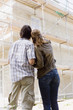 Couple Looking at New Home Construction, rear view