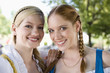 Germany, Bavaria, Upper Bavaria, Three women in traditional costume, smiling, portrait, close-up