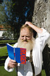 Photo: Germany, Bavaria, Upper Bavaria, Bavarian man reading travel book, close-up Germany, Bavaria, Upper Bavaria, Bavarian man reading travel book, close-up