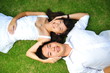 Happy and Loving Couple Lying On The Grass