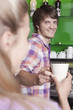 Germany, Cologne, Man handing coffee over counter