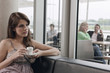 Germany, Cologne, Woman in cafe holding cup of espresso