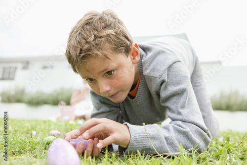 Photo: Boy looking at an Easter egg Boy looking at an Easter egg