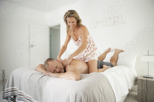 Photo: Woman massaging back of a man Woman massaging back of a man