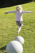 Rear view of a girl jumping from a stone