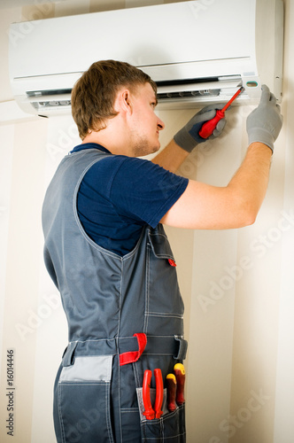 Photo: man repair air-conditioner man repair air-conditioner
