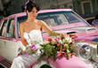 Bride on pink limousine