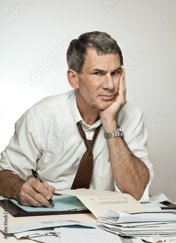 Photo: Worried Unhappy Man Paying Bills Worried Unhappy Man Paying Bills