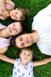 Family lying on grass