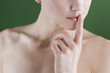 A young woman touching her lips
