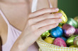 A woman holding an Easter egg, close-up
