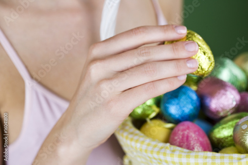 Photo: A woman holding an Easter egg, close-up A woman holding an Easter egg, close-up