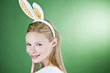 A young blonde woman wearing rabbit ears