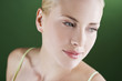 A portrait of a young blonde woman looking over her shoulder