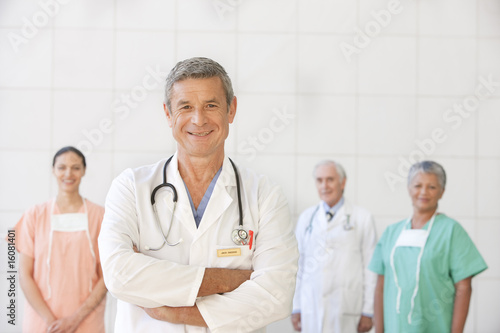 Photo: portrait of senior doctor with staff portrait of senior doctor with staff