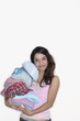 Woman indoors holding pile of hats