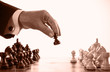 businessman playing chess game sepia tone