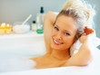 Cute woman relaxing in a bubble bath