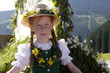 Austria, Salzburg land, Girl in traditional costume sitting in wagon