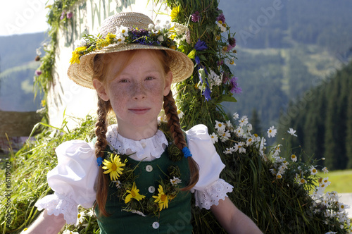Photo: Austria, Salzburg land, Girl in traditional costume sitting in wagon Austria, Salzburg land, Girl in traditional costume sitting in wagon