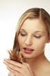 young woman holding strand of hair