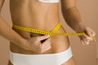 Woman measuring her waist