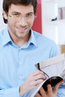 Young man holding a magazine