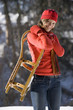 Woman holding sledge, smiling, portrait