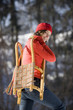 Woman holding sledge, smiling, portrait