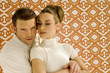 Young couple against wall paper, portrait