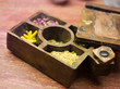 Compartmented wooden box with various herbs, close-up