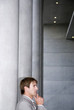 Businessman standing with hand on chin, side view