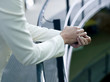 Businesswoman leaning on railings, mid section, close-up