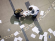 Couple in hall collecting papers, elevated view