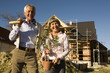 Senior couple in front of partially built house