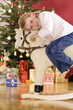 Girl (3-5) sitting on rocking horse smiling, close-up, side view