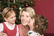 Grandmother embracing grandchildren on Christmas Eve